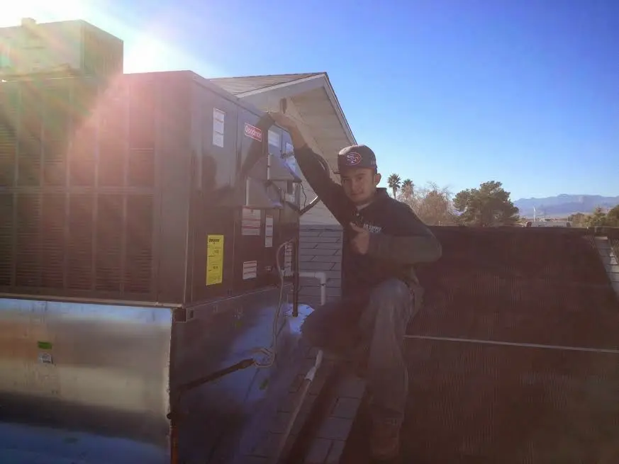 HVAC technician performing HVAC Inspection on a rooftop unit in South Burlington